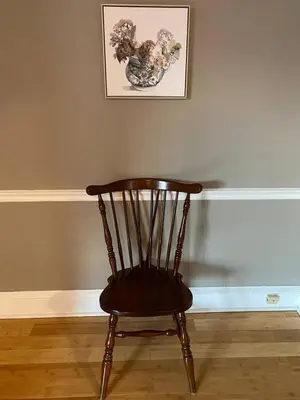 a wooden chair in a room with a picture of a dog at Bryn Mawr Spacious Grnd Floor Apt Free Parking in Bryn Mawr