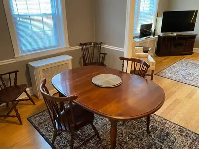 a dining room with a wooden table and chairs at Bryn Mawr Spacious Grnd Floor Apt Free Parking in Bryn Mawr