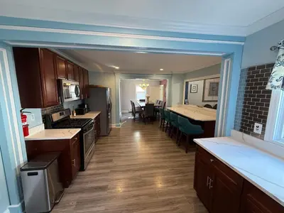 a kitchen with wooden floors and a kitchen with a counter top at Gythio in Keansburg