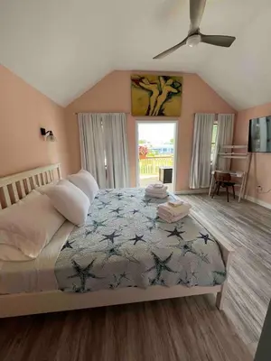 a bedroom with a bed and a ceiling fan at Odessa in Keansburg