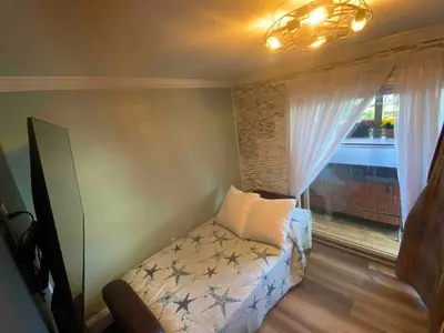 a bedroom with a bed and a window at Odessa in Keansburg