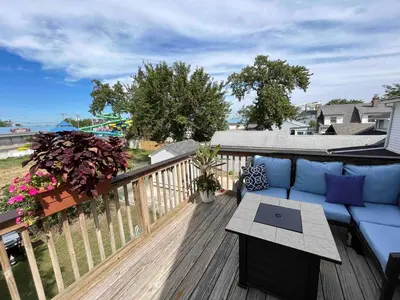a patio with a blue couch on a wooden deck at Odessa in Keansburg