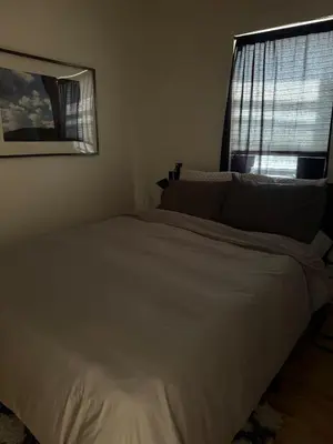 a white bed in a bedroom with a window at Modern Stay in Downtown Jersey City, Close to NYC! in Jersey City