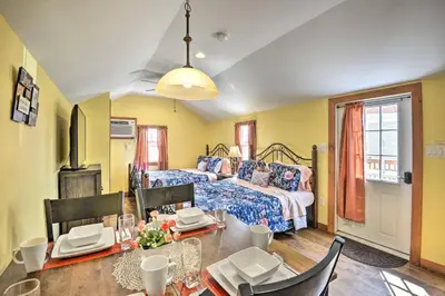 a bedroom with a bed and a table with chairs at Triple Suites Close to Skiing in Pleasant Mount