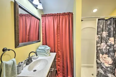 a bathroom with a sink and a red shower curtain at Triple Suites Close to Skiing in Pleasant Mount