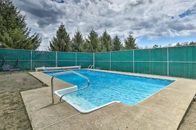 a large swimming pool with a fence around it at Triple Suites Close to Skiing in Pleasant Mount
