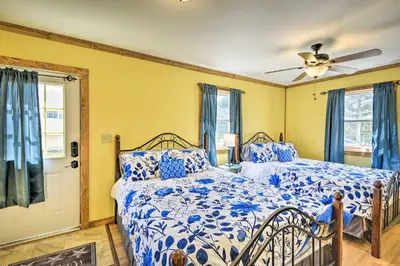 a bedroom with a bed and a ceiling fan at Quadruple Suites At Equestrian House in Pleasant Mount