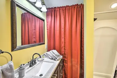 a bathroom with a sink and a red shower curtain at Premium Cottages And Suites At Equestrian House in Pleasant Mount