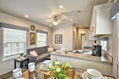 a kitchen and living room with a couch and a table at Romantic Escape Cottage and Suites Close to Ski Trails in Pleasant Mount