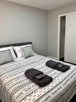 a bedroom with a bed with two towels on it at Peaceful 3BR House w Easy NYC Access in South River, NJ in South River