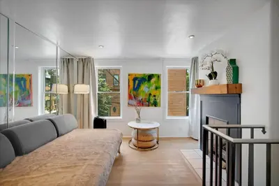 a living room with a couch and a fireplace at The Twisty Nest on 17th in Philadelphia