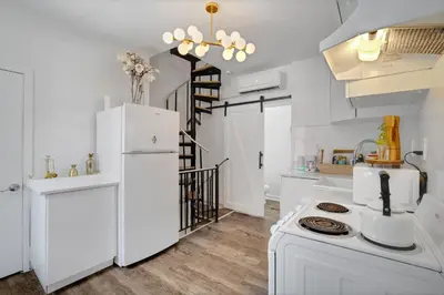 a kitchen with white appliances and a white refrigerator at The Twisty Nest on 17th in Philadelphia