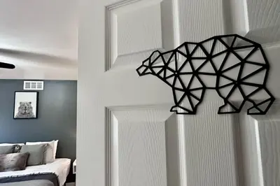 a black and white room with a bed and a lamp at Pocolonial Charming 4BR Mountain Retreat in Albrightsville