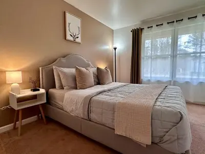 a bedroom with a large bed and a window at Pocolonial Charming 4BR Mountain Retreat in Albrightsville