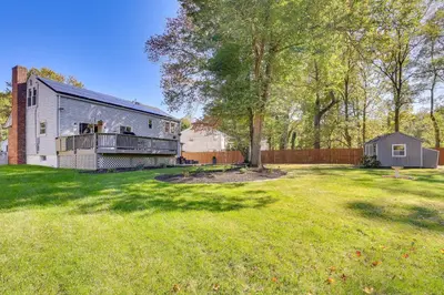 an empty yard with a house and a fence at Spacious Fanwood Home with Decks, Walk to Park!