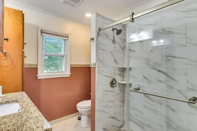 a bathroom with a shower and a toilet at Spacious Fanwood Home with Decks, Walk to Park!