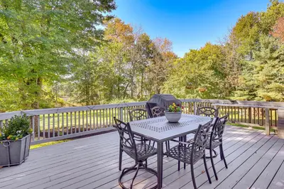 a table and chairs on a wooden deck at Spacious Fanwood Home with Decks, Walk to Park!