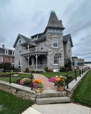 a large stone house with flowers in front of it at The Willough in Conshohocken