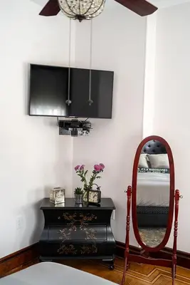a mirror and a dresser in a room with a bed at The Willough in Conshohocken