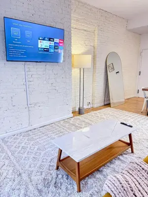 a living room with a tv and a coffee table at Residence Heritage Giant 3 Bedroom in New York