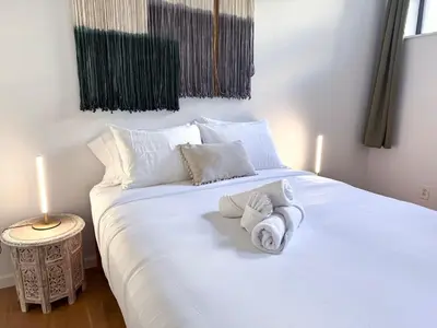 a bedroom with a white bed with towels on it at Residence Heritage Giant 3 Bedroom in New York