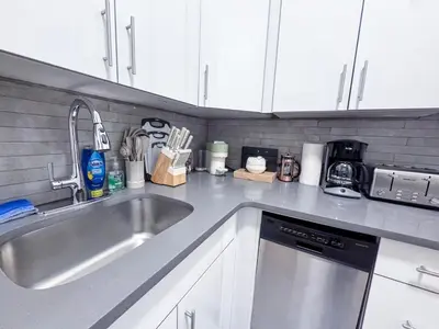 a kitchen with a sink and a counter top at Residence Heritage Giant 3 Bedroom in New York