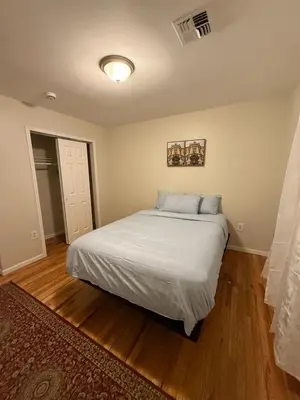 a bedroom with a white bed in a room at Urban haven 3 Kings bedroom near EWRNYC DTW in Newark