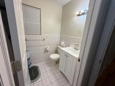 a bathroom with a white toilet and a sink at Urban haven 3 Kings bedroom near EWRNYC DTW in Newark