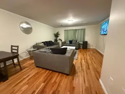 a living room with a couch and a table at Urban haven 3 Kings bedroom near EWRNYC DTW in Newark