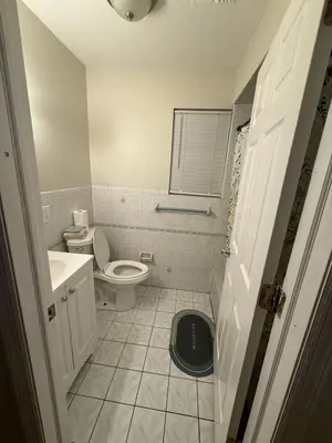 a small bathroom with a toilet and a sink at Urban haven 3 Kings bedroom near EWRNYC DTW in Newark