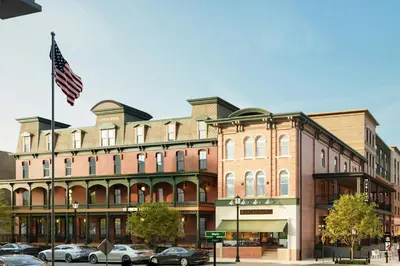 a large brick building with an american flag at The Union Hotel, Flemington, a Tribute Portfolio Hotel in Flemington