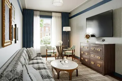 a living room with a couch and a tv at The Union Hotel, Flemington, a Tribute Portfolio Hotel in Flemington