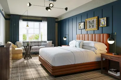 a bedroom with a large bed and a living room at The Union Hotel, Flemington, a Tribute Portfolio Hotel in Flemington