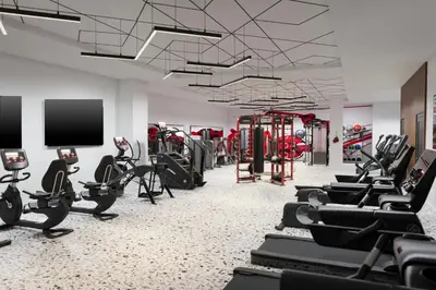 a gym with rows of treadmills and exercise bikes at The Union Hotel, Flemington, a Tribute Portfolio Hotel in Flemington
