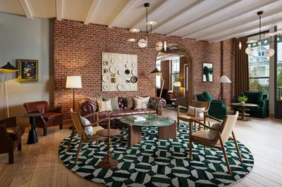 a living room filled with furniture and a brick wall at The Union Hotel, Flemington, a Tribute Portfolio Hotel in Flemington