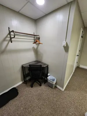 a room with a table and a wall with a door at Dunnstown Lodge in Lock Haven