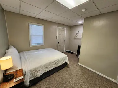 a bedroom with a large bed and a window at Dunnstown Lodge in Lock Haven