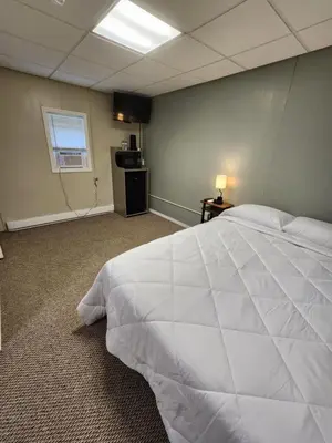 a bedroom with a large white bed in a room at Dunnstown Lodge in Lock Haven