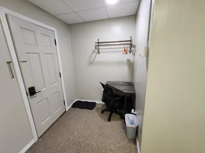 a hallway with a door and a desk in a room at Dunnstown Lodge in Lock Haven