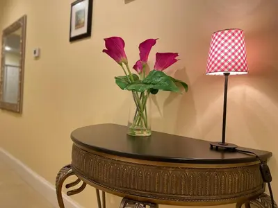 a vase of flowers on a table next to a lamp at Spacious Guest Suite 5 Minutes to Princeton University with Free Parking in Princeton