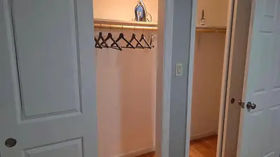 a room with a closet with a door with hangers at Work & Stay - NYC - EWR - Train Walk in Newark