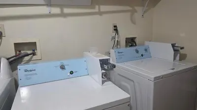 a laundry room with a washer and dryer at Work & Stay - NYC - EWR - Train Walk in Newark