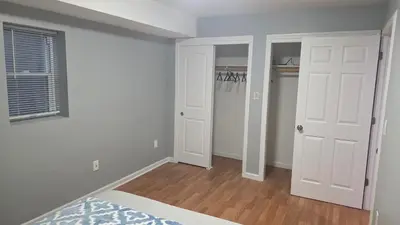 an empty room with white walls and white doors at Work & Stay - NYC - EWR - Train Walk in Newark