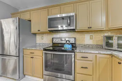 a kitchen with a stove and a microwave at Hike, Ski and Explore Otisville Retreat with Yard! in Otisville
