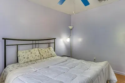 a white bedroom with a bed and a ceiling fan at Hike, Ski and Explore Otisville Retreat with Yard! in Otisville