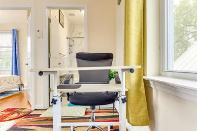a desk and a chair in a room with a window at Quiet Newark Apt Near Colleges, Arenas and Hospitals in Newark