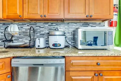 a kitchen counter with a microwave and a stove at Quiet Newark Apt Near Colleges, Arenas and Hospitals in Newark