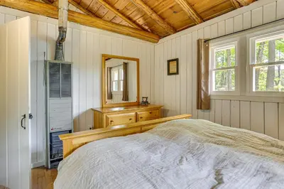 a bedroom with a bed and a dresser and a mirror at Boat, Hike and Fish Rustic Greenwood Retreat in Greentown