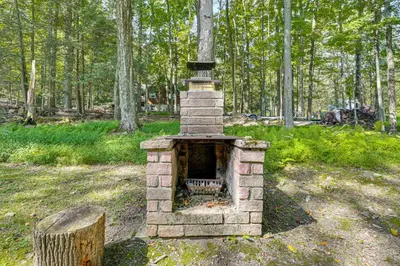 a brick oven in the middle of a forest at Boat, Hike and Fish Rustic Greenwood Retreat in Greentown