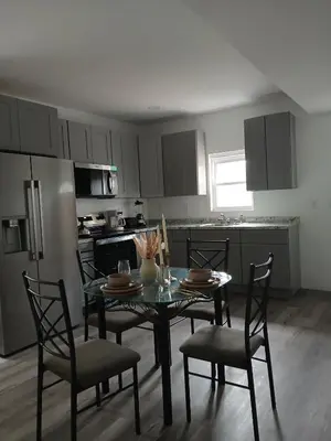 a kitchen with a table and chairs in a kitchen at Labelle in Wilkes-Barre